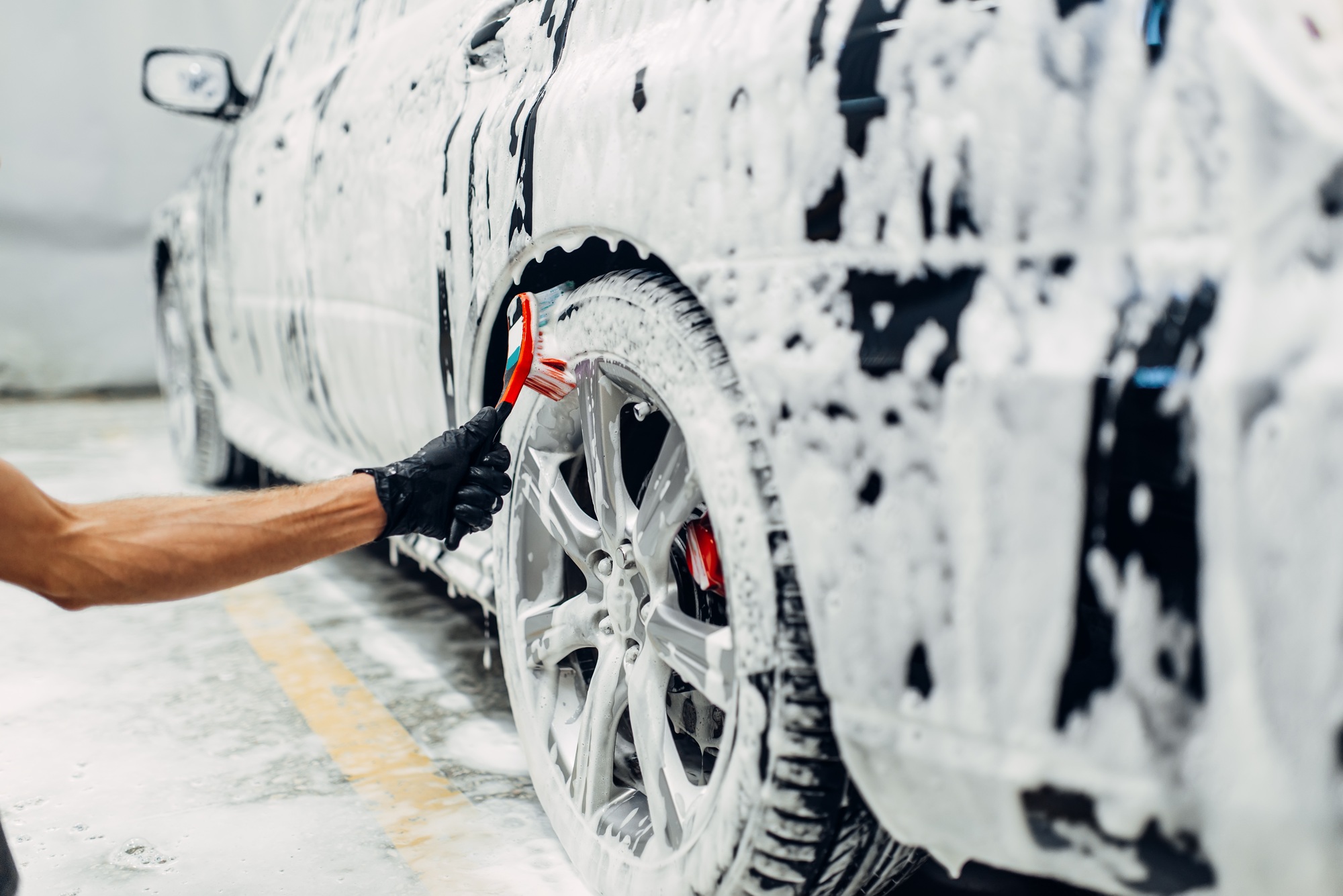 Carwash service, washing of wheels with brush